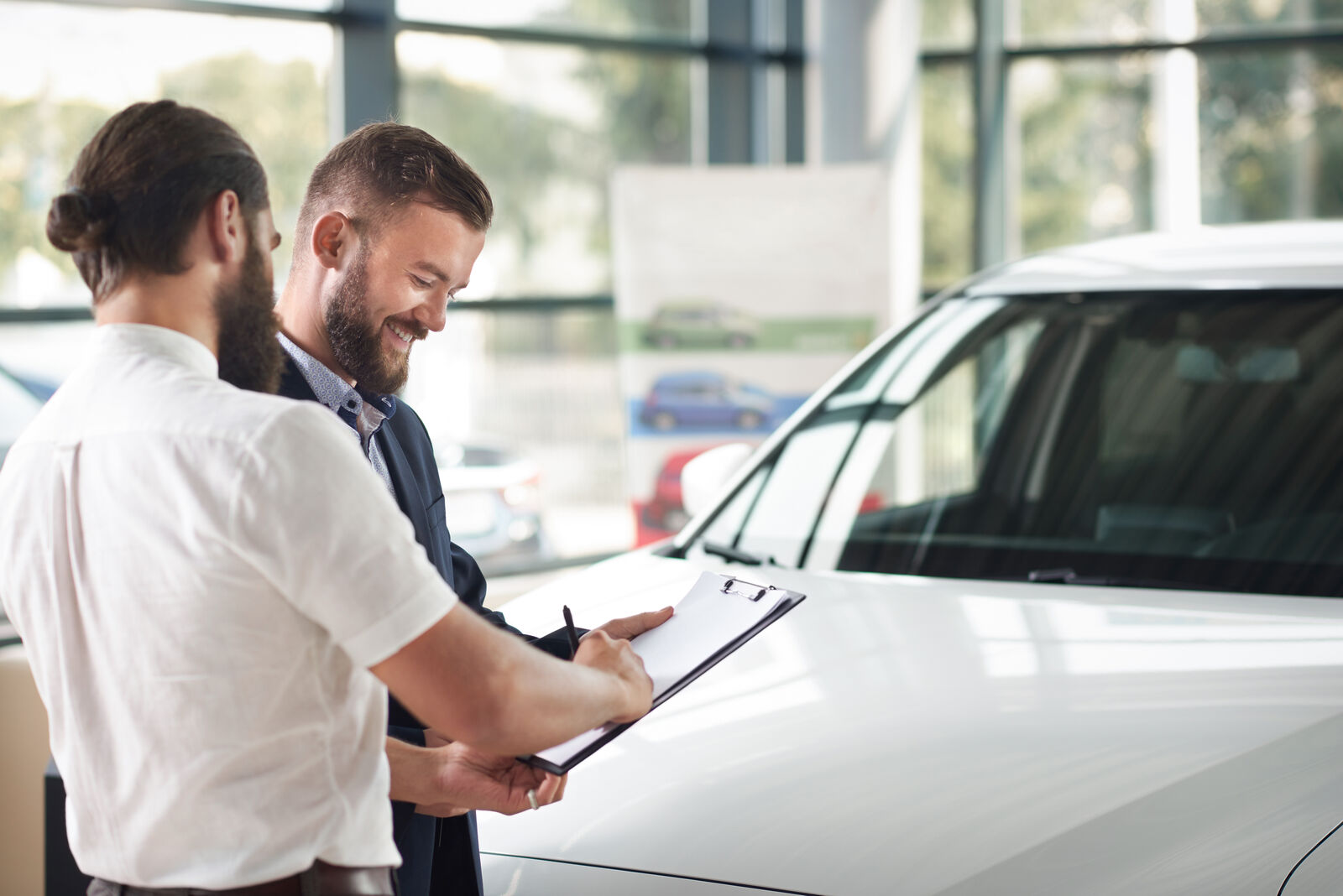 Couple comparing car options and negotiating at a dealership