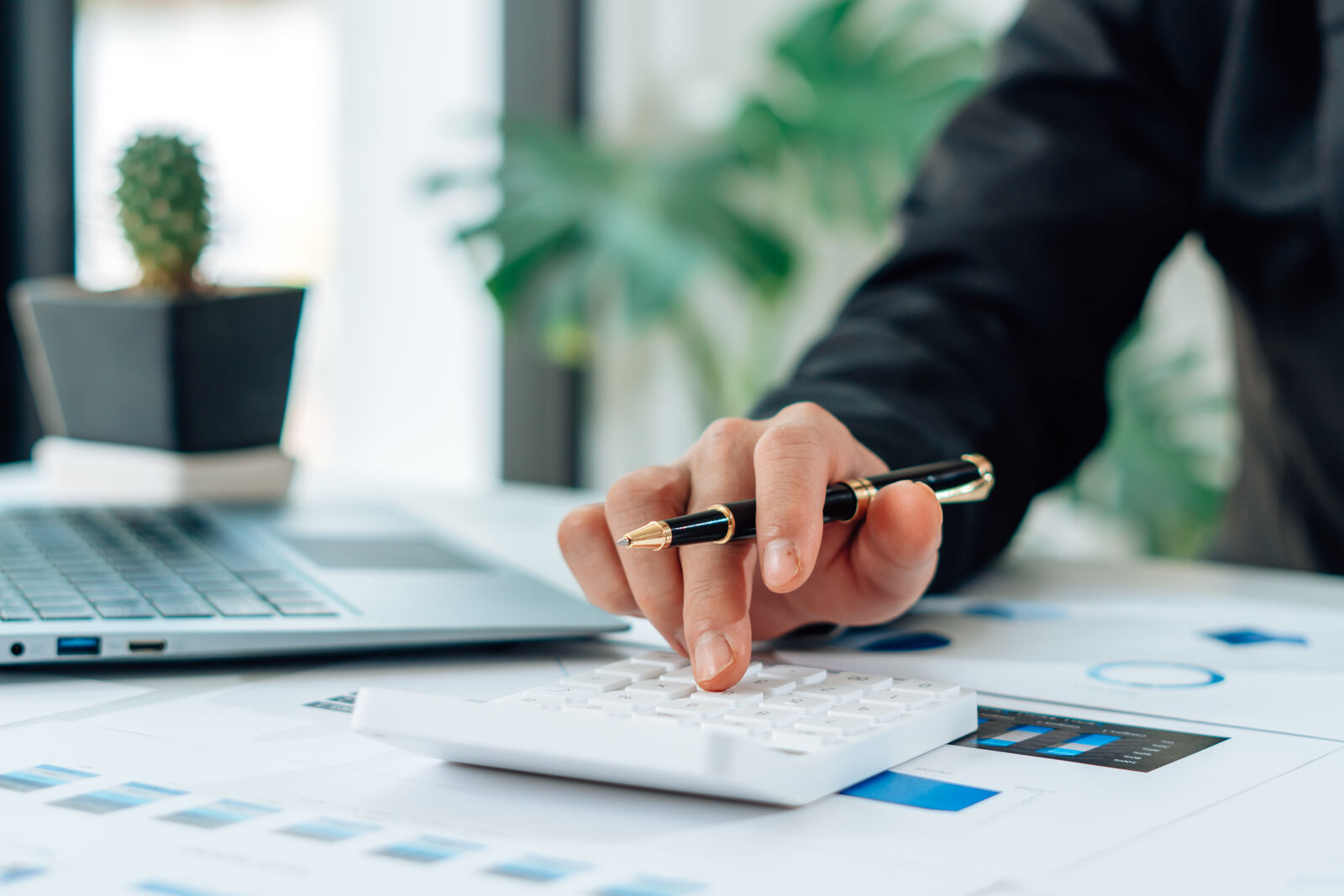 Person reviewing credit report on a tablet with coffee